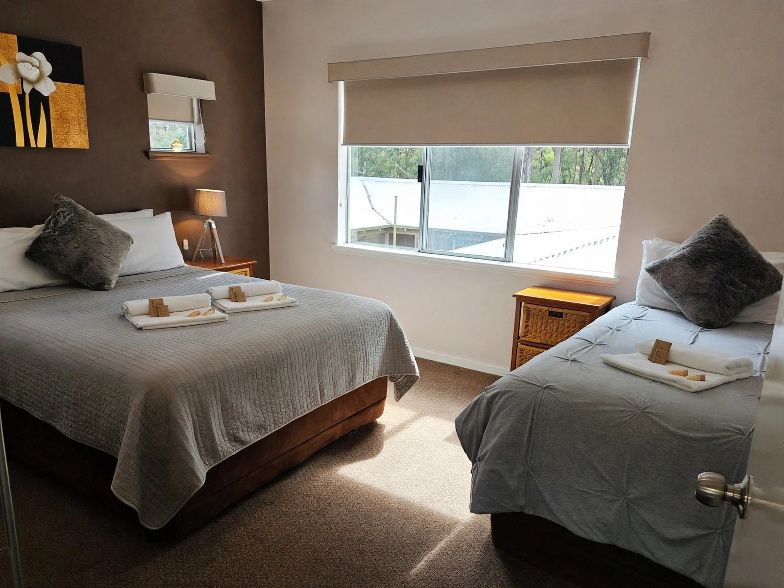 Apartment room with two dressed beds and a window seat — enhanced sample photo